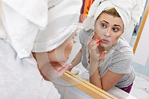 Woman looking at her reflection in mirror