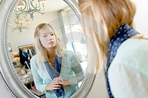 Woman looking at herself in mirror