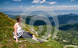 Woman looking from the hill on beautiful landscape