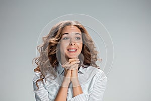 Woman is looking imploring over gray background