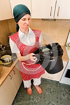 Woman Looking inside a Trash Can