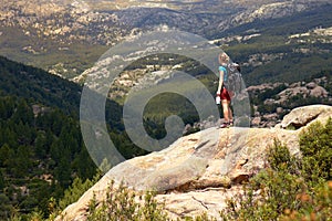 Woman looking at the landscape with a protective mask in her hand. Concept of freedom