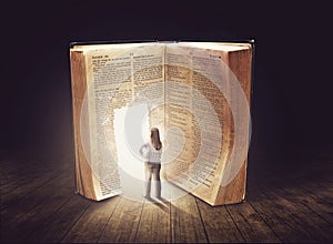 Woman looking at large book photo