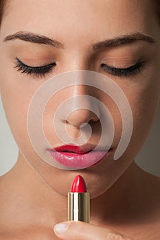 Woman Looking at Lipstick