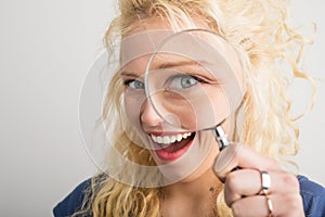 Woman looking through magnifying glass