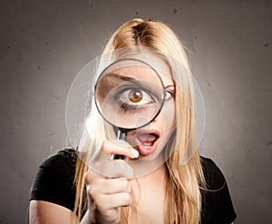 Woman looking through magnifying glass