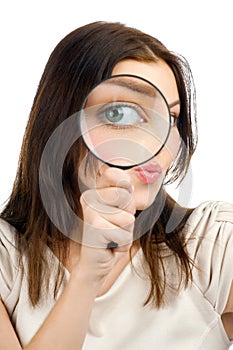 Woman looking through a magnifying glass