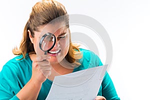 Woman looking through magnifying glass