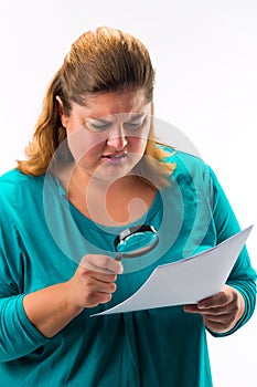 Woman looking through magnifying glass