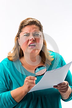 Woman looking through magnifying glass