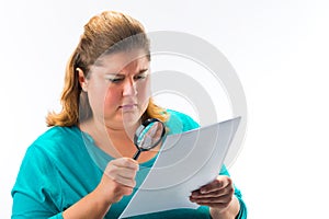 Woman looking through magnifying glass