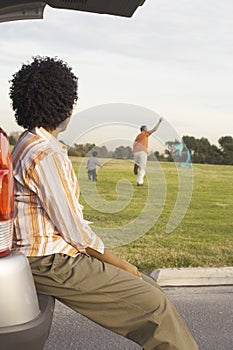 Woman Looking At Man And Child Playing With Kite