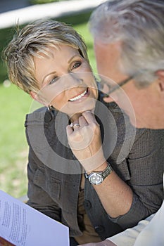 Woman Looking At Man Reading Novel