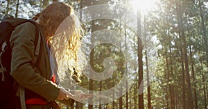 Woman looking at map in the forest 4k