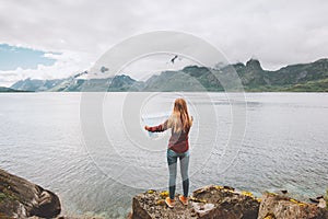 Woman looking at map planning vacation trip traveling solo in Norway