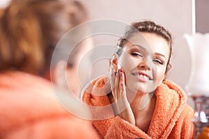 Woman looking in the mirror photo