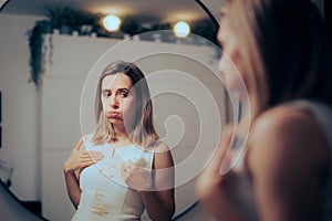 Woman Looking in the Mirror Checking out the Stains on her Dress