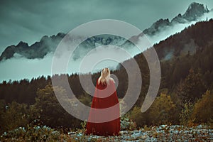 Woman looking misty mountains