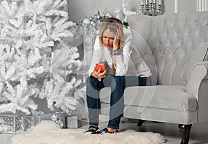 Woman looking at mobile phone in depression during Christmas