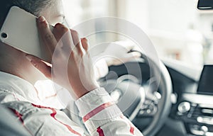 Woman looking at mobile phone while driving a car. Driver using smart phone in car.