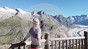 Woman looking at Moosfluh viewpoint