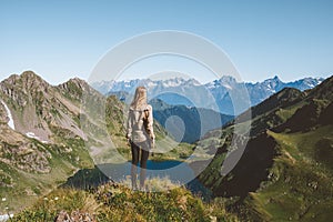 Woman looking at mountain lake view travel adventure hiking outdoor active healthy lifestyle