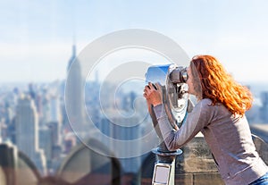 Woman looking in observation binoculars.