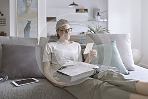 Woman looking at old pictures in the photobook