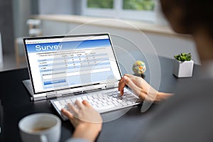 Woman Looking At Online Computer Survey