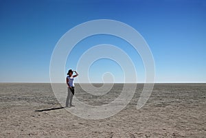 Woman looking out over Etosha pan