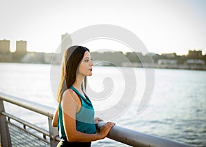 Woman looking over Hudson river at sunset