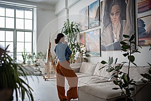 Woman looking at painting, Artist creative studio. Artist apartment gallery interior, Artwork hobby