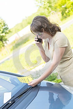 Woman looking on parking ticket