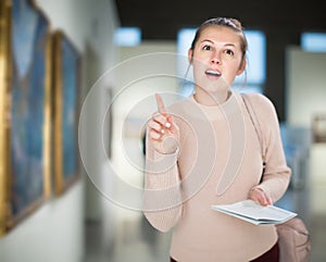 Woman looking at pictures and amaze in museum