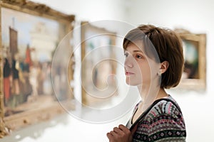 Woman looking pictures in museum