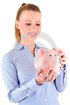 Woman looking at a piggy bank