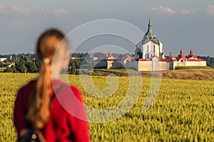 woman looking at the Pilgrimage Church of Saint John of Nepomuk at Zelena Hora, Zdar nad Sazavou, Czech republic