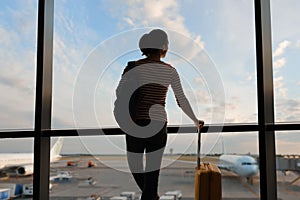 Woman looking at a plane at the airport