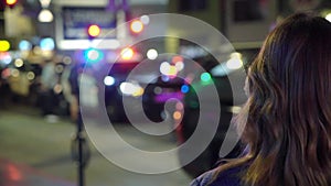 Woman looking at police in a night city