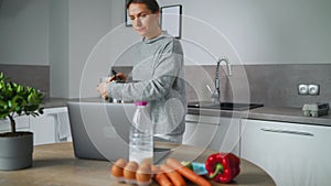 Woman looking recipe online while cooking