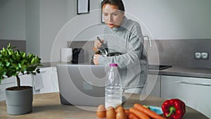 Woman looking recipe online while cooking