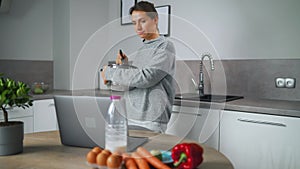 Woman looking recipe online while cooking