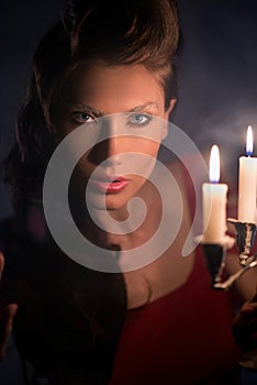 Woman looking on red candles in the fabulous night