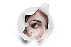 Woman Looking Through Ripped Paper Hole