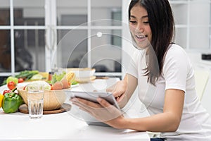 Woman looking for salad diet menu in tablet