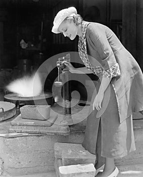 Woman looking at a scale in a foundry