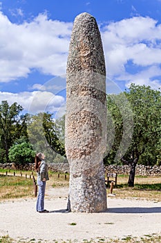 Woman looking at the Standing Stone / Menhir of Meada, the largest of the Iberian Peninsula photo