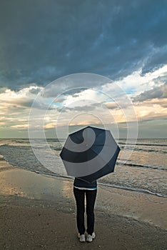 A woman looking at the stormy sea