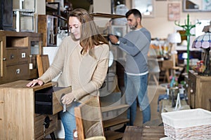 Woman looking for stylish small cabinet