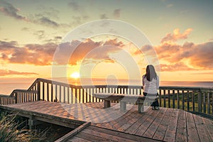 Woman looking at sunset at Hallett Cove boardwalk